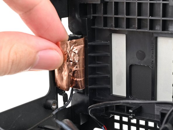 Use your fingers to peel the right antenna's copper film off the chassis.