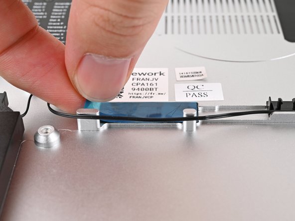Remove the blue liner from the black tape near the left Speaker.