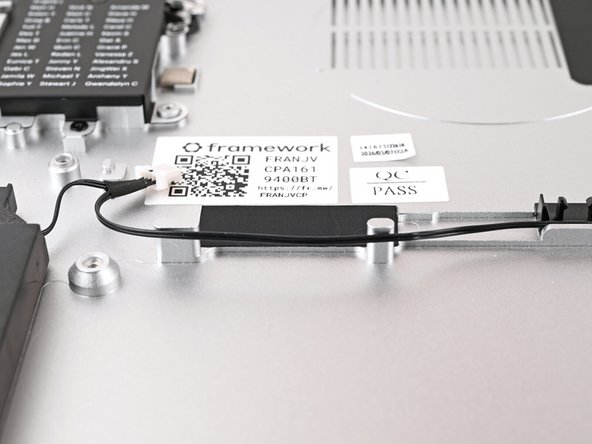 Remove the blue liner from the black tape near the left Speaker.