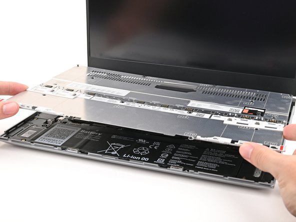 Place the Mid Plate on the laptop, making sure it sits evenly on its alignment pegs.