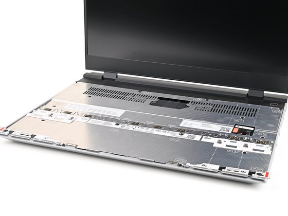 Place the Mid Plate on the laptop, making sure it sits evenly on its alignment pegs.