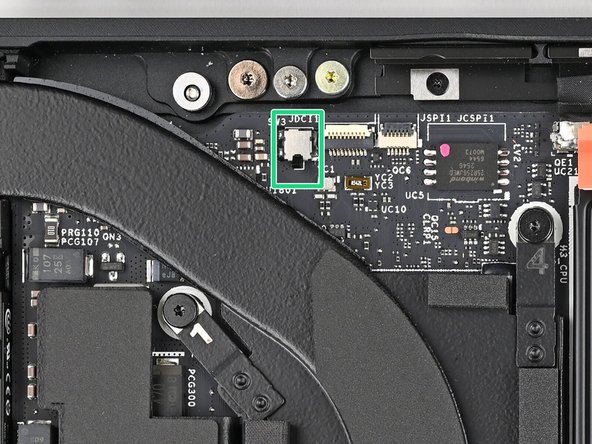 This switch is a sensor that detects if the Input Cover has been removed. It's a small silver block with a black toggle tab.