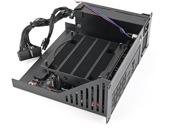 Align the I/O ports with its cutout in the Tray and the screw posts with the screw holes on the Mainboard.