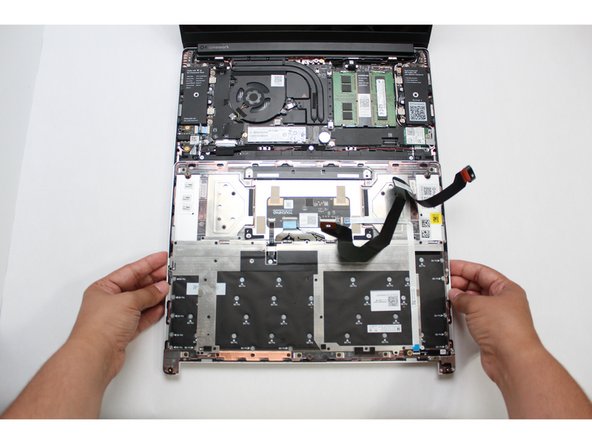 Gently place the Input Cover keyboard side down on the Bottom Cover as indicated on the image. The cover should be about an inch and a half away from the bottom of the Mainboard so that you can comfortably install the Touchpad Cable.