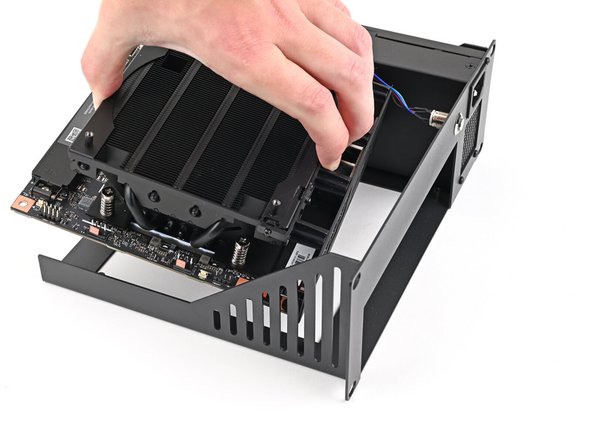 Grab the Mainboard by its heatsink and slide it into the Tray with its I/O ports facing the front.