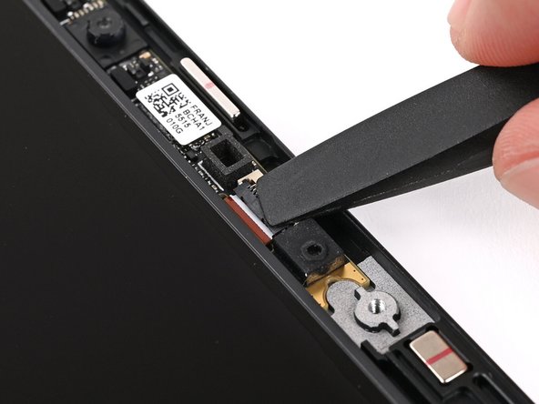 Use the flat end of your Framework Screwdriver, or a clean fingernail, to press down the locking tab on the Webcam ZIF connector.