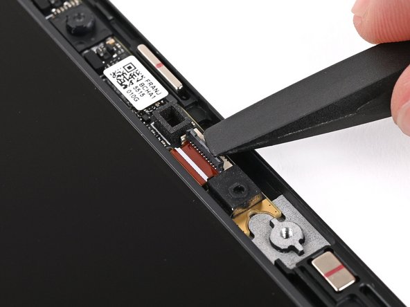 Use the flat end of your Framework Screwdriver, or a clean fingernail, to press down the locking tab on the Webcam ZIF connector.