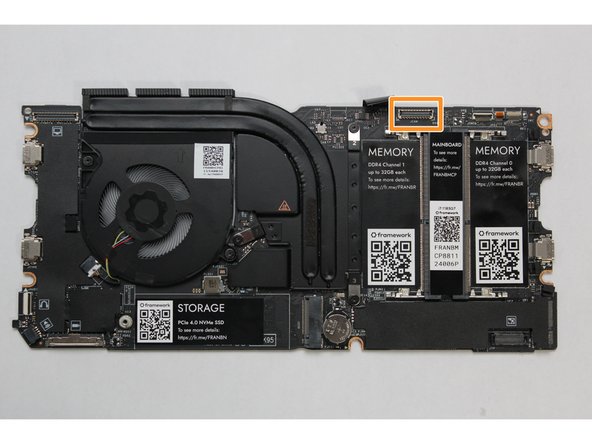 Hold the pull tab on the Webcam Cable and connect it into the Mainboard by aligning the pins from the cable with the socket pins on the Mainboard.