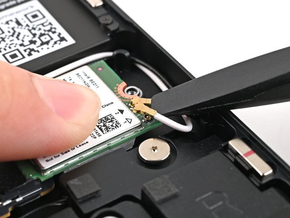 Lift the screwdriver straight up to disconnect the coaxial cable.