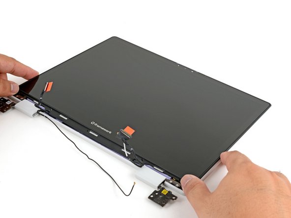 Lay the display in place in the Top Cover, such that the top edge of the display is slightly below the top edge of the Top Cover.