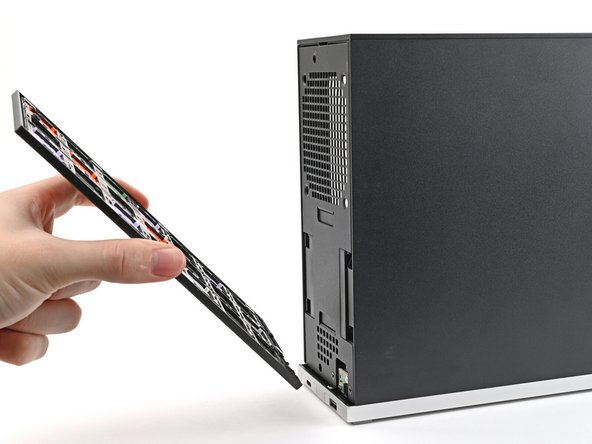 Lay the bottom of the Front Panel on the small, protruding lip in the silver base to align its tabs.