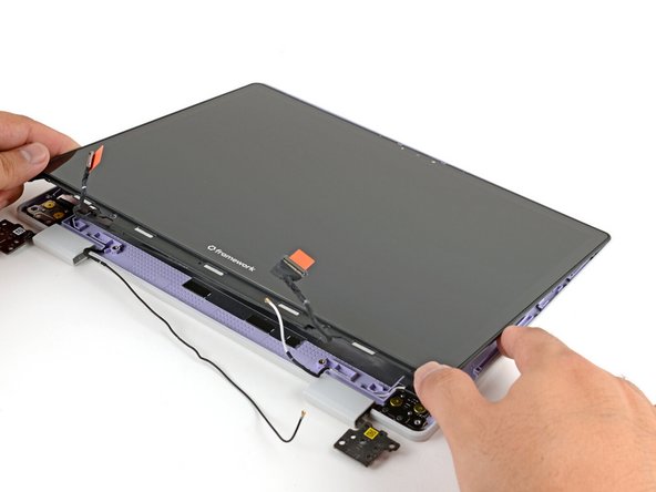 Lay the display in place in the Top Cover, such that the top edge of the display is slightly below the top edge of the Top Cover.