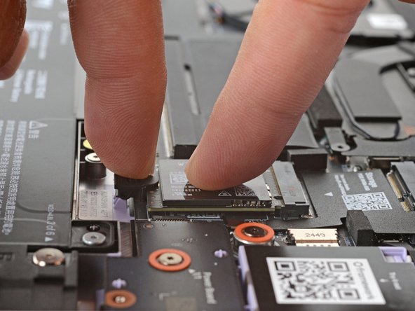 If the SSD doesn't fit in the latch, you may need to insert the SSD further into its socket.