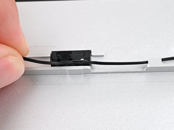 If you're having difficulty pressing the speaker cable into its plastic clips, twist the cable so it's vertical and use the flat end of your Framework Screwdriver to press it down.