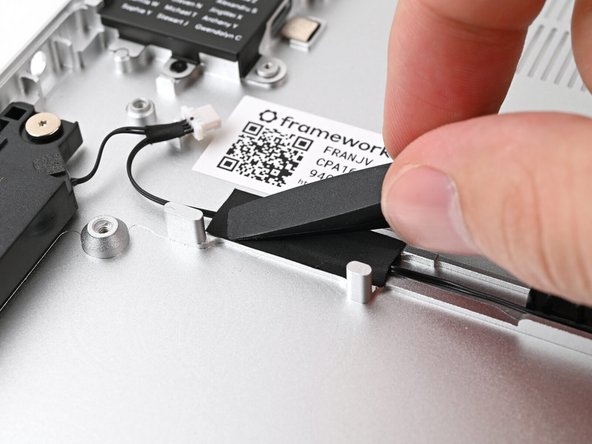 Press the tape over the Speaker Cable to adhere it to the Chassis.