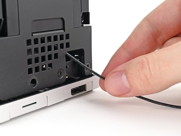 Pull the Power Button Board away from the Desktop, threading its cable through the chassis.