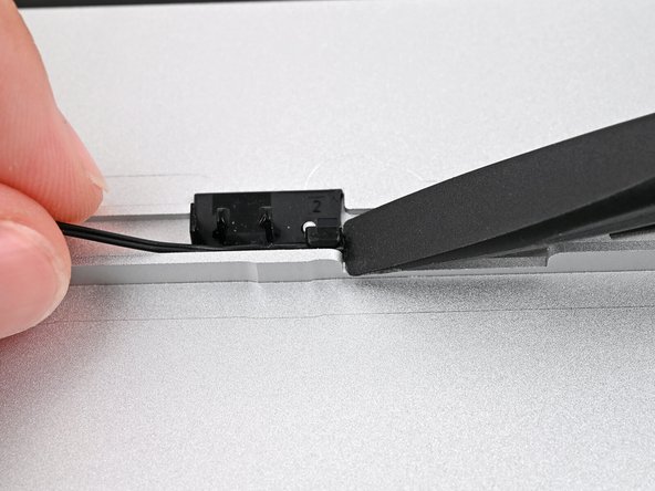 If you're having difficulty pressing the speaker cable into its plastic clips, twist the cable so it's vertical and use the flat end of your Framework Screwdriver to press it down.