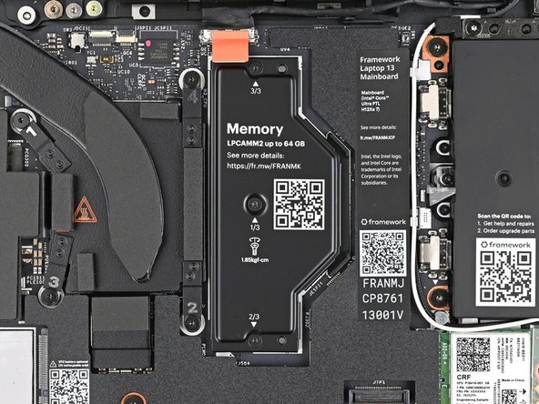 Use your Framework Screwdriver to loosen the captive T5 Torx screws securing the LPCAMM2 Memory Cover in reverse order from 3–1.