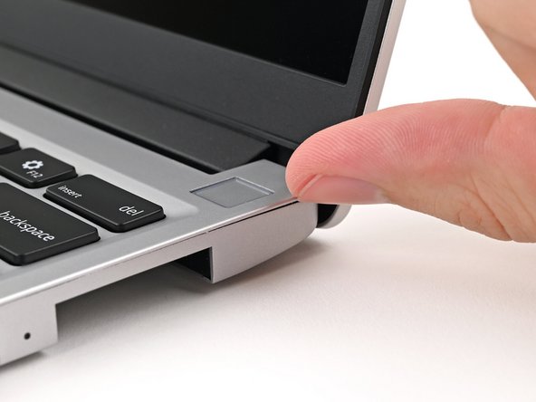 Flip over the laptop and open it.