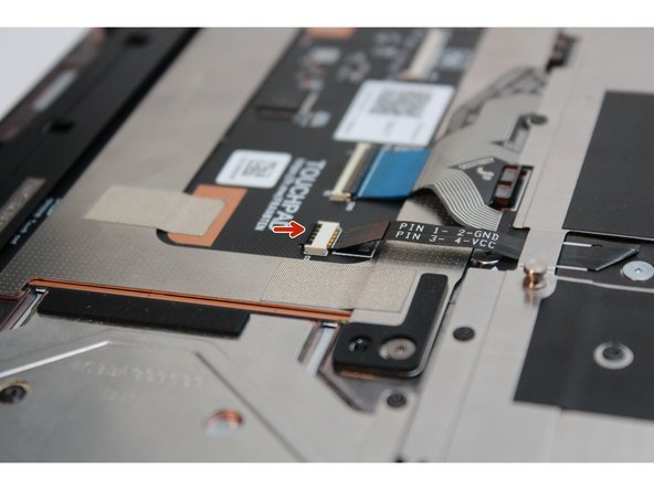 Using the spudger end of the Framework Screwdriver or your fingernail, disconnect the Keyboard backlight cable by flipping up the black latch up on the connector located on the Touchpad Module.