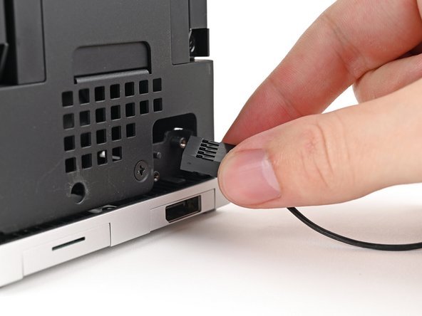 Pull the Power Button Board away from the Desktop, threading its cable through the chassis.