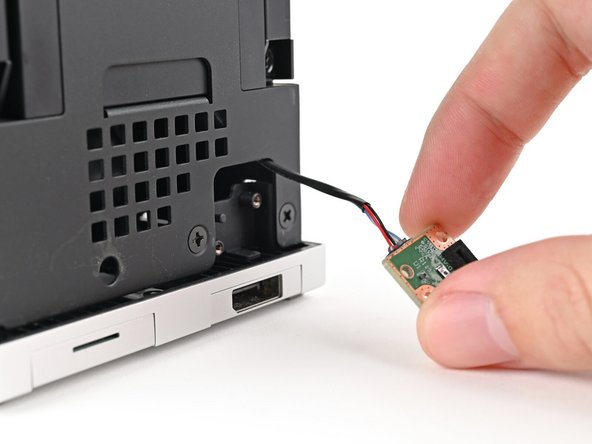Pull the Power Button Board away from the Desktop, threading its cable through the chassis.