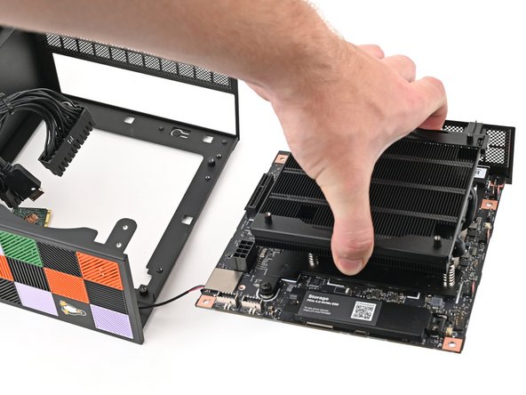 Grab the Mainboard by its heatsink and slide it into the chassis.