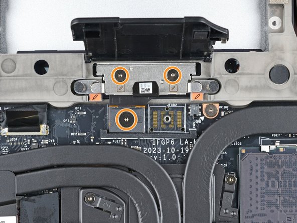 If you have the Graphics Module, use your Framework Screwdriver to loosen the four captive T5 Torx screws securing the interposer.