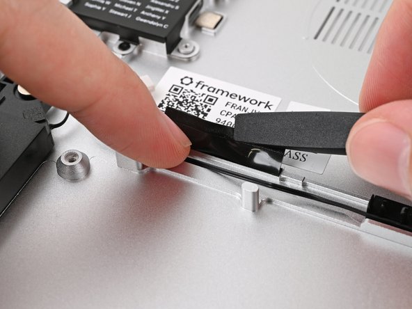 Press the tape over the Speaker Cable to adhere it to the Chassis.