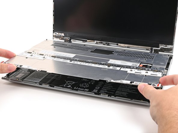 Use your fingers to lift the Mid Plate off the laptop and remove it.