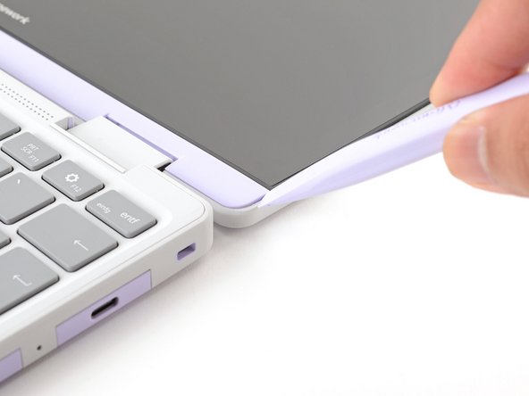 The Display Cover is held in place with magnets along the top edge and clips along the remaining edges.