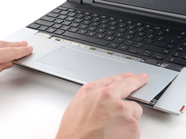 Place the Touchpad Module flat on its cutout so its clips are properly aligned.