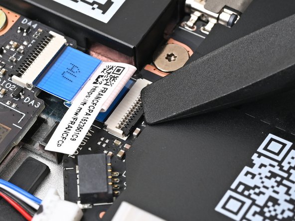 Use the flat end of your Framework Screwdriver, or a clean fingernail, to press down the locking tab on the Audio Board ZIF connector.