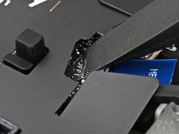 Use the flat end of a spudger, or a clean fingernail, to press down the locking tab on the fingerprint sensor ZIF connector.