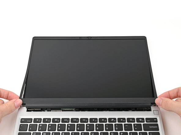 Lift the bezel around the perimeter of the screen until all of its magnets are released.