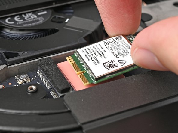 Hold the Wi-Fi module by its edges. Don't touch the gold contacts with your fingers. If you do, wipe the contacts with a clean, lint-free cloth to remove any finger oils.