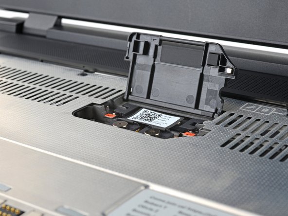 Lift the interposer door by its black pull tab and let it rest upright.