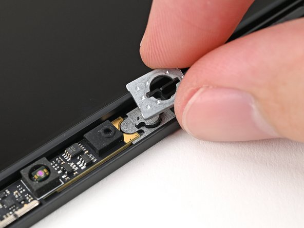 Use your fingers to place the washers into their spots on the Top Cover.