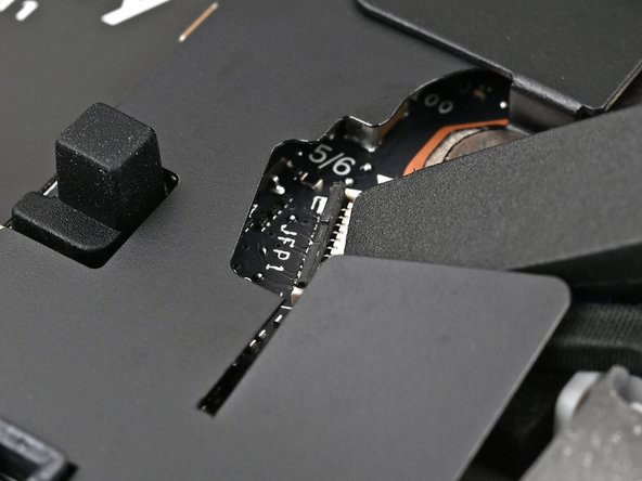 Use the flat end of a spudger, or a clean fingernail, to press down the locking tab on the fingerprint sensor ZIF connector.