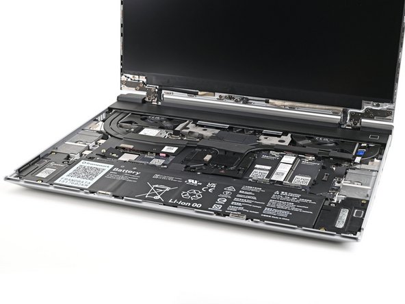 Use your fingers to lift the Mid Plate off the laptop and remove it.