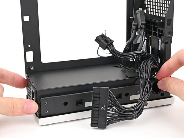 Place the power supply into its slot in the bottom of the Desktop.