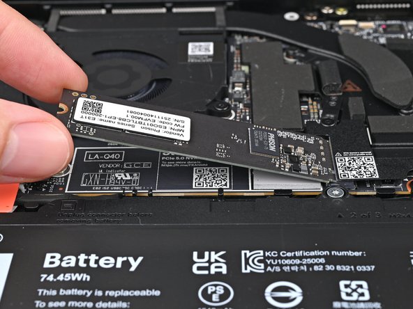Insert the SSD into the socket at a shallow angle. The gold contacts should mostly be covered by the socket.