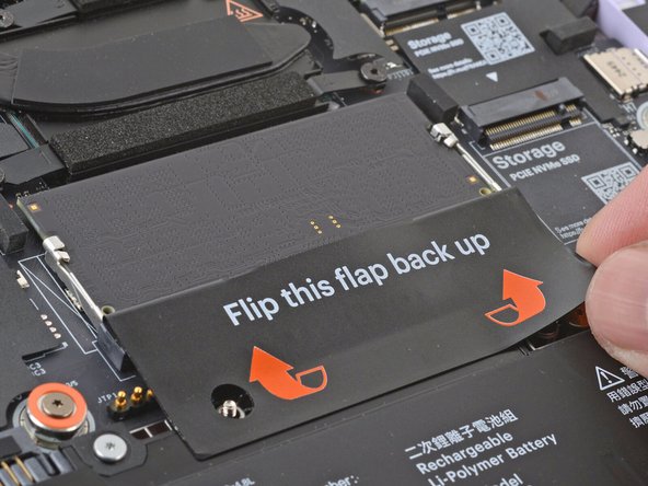 Use your fingers to flip open the memory flap.