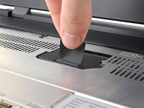 Lift the interposer door by its black pull tab and let it rest upright.