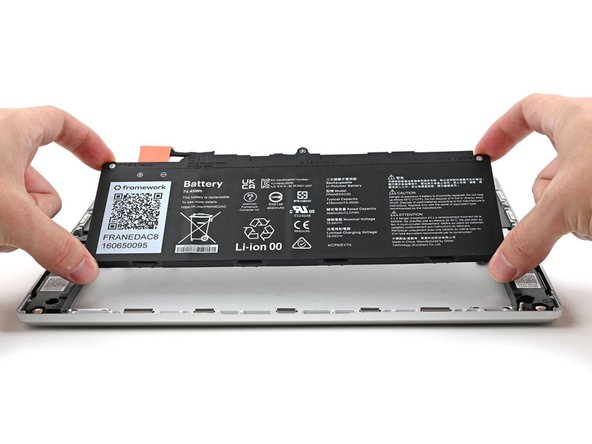 Insert the Battery into its cutout, making sure its plastic tabs are slotted into the Bottom Cover.