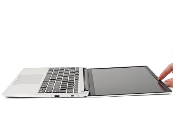 Open the laptop so the screen sits flat on your work surface.
