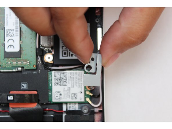 Remove the fastener and gently lift off the WiFi Bracket.