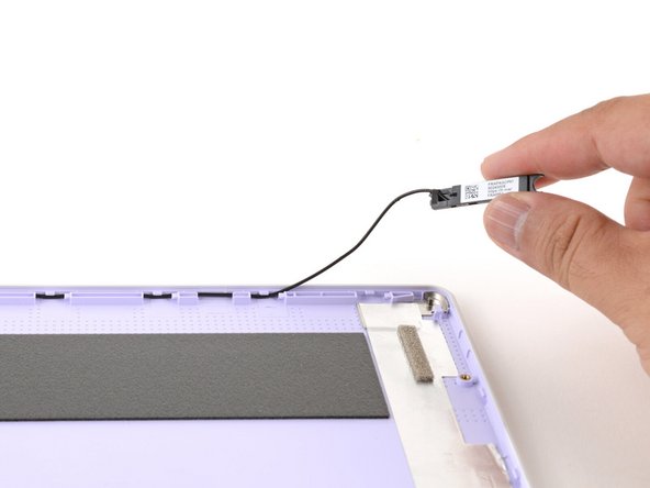 Repeat the previous step to guide the black antenna cable out of its channel.