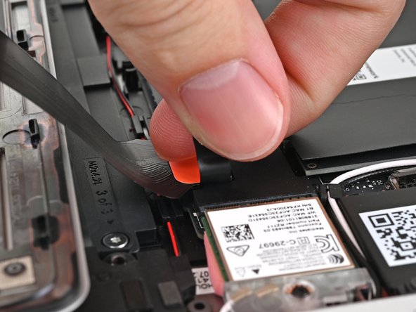 Insert your finger into the Touchpad Cable press connector loop.