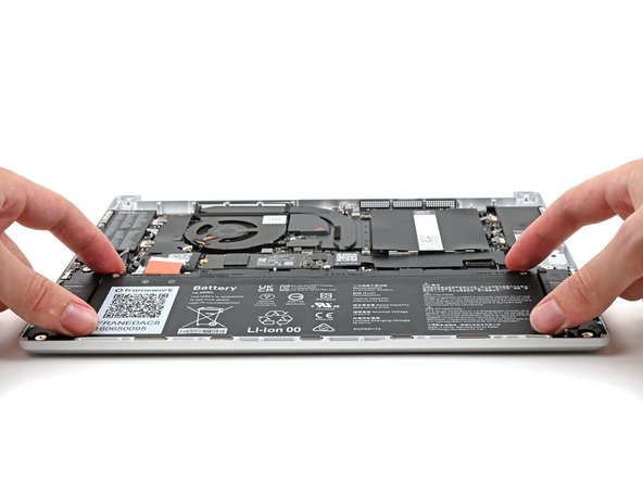 Insert the Battery into its cutout, making sure its plastic tabs are slotted into the Bottom Cover.